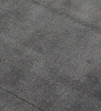 A close-up texture shot of a dark gray plush or short-pile fabric surface, showing the fine looped material detail.