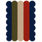 A rectangular area rug with a scalloped edge and vertical stripes in navy blue, olive green, beige, and red on a white background.