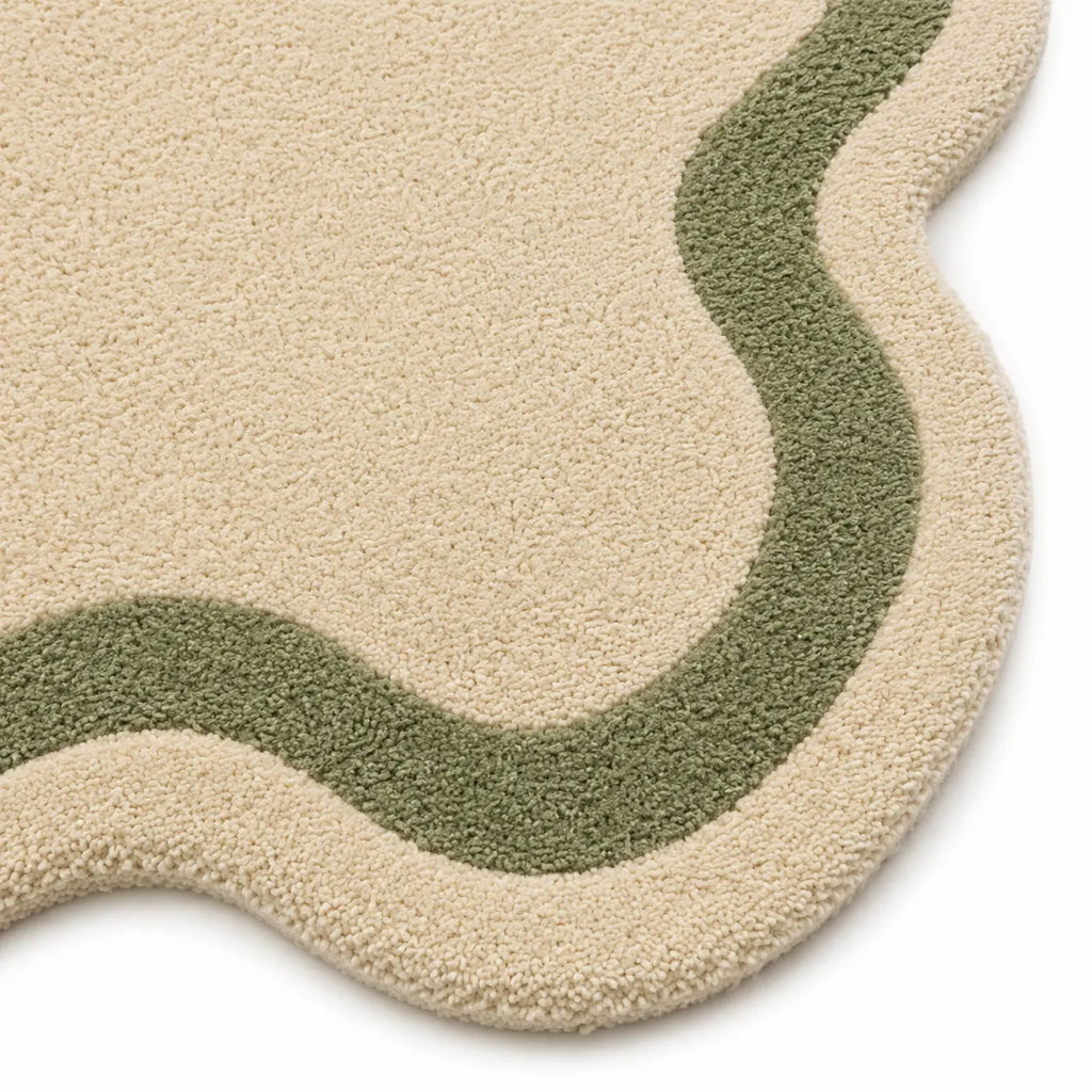 Beige and green textured rug on a white background