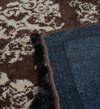 Brown wool rug with ivory damask motifs in distressed design