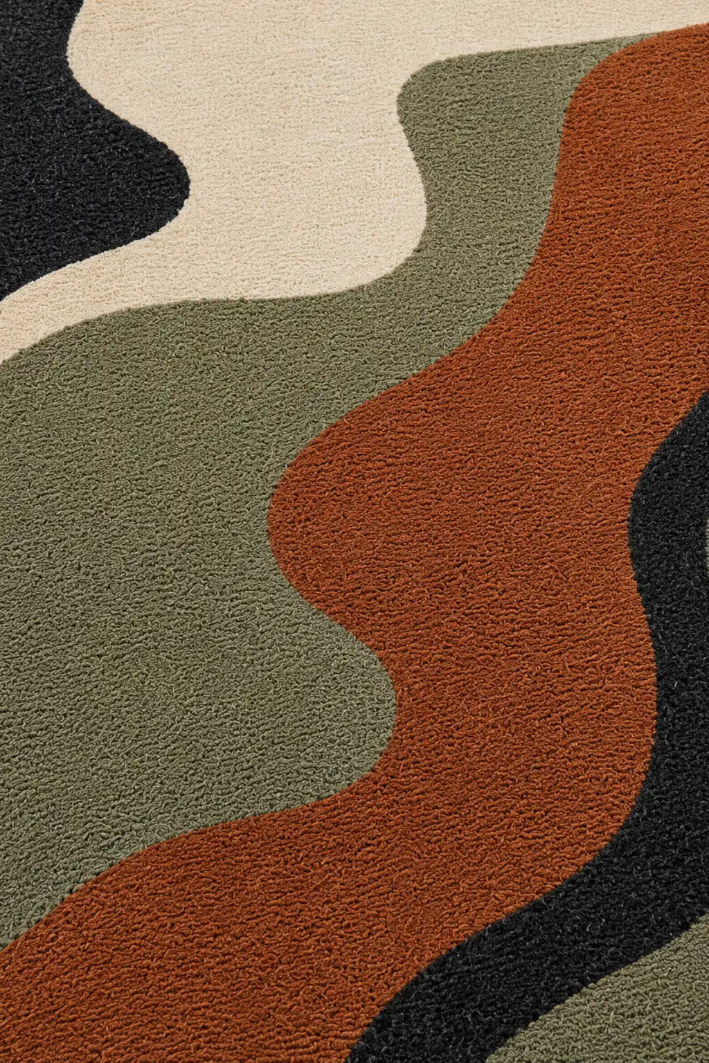 Camouflage patterned rug with brown, green, black, and beige colors.