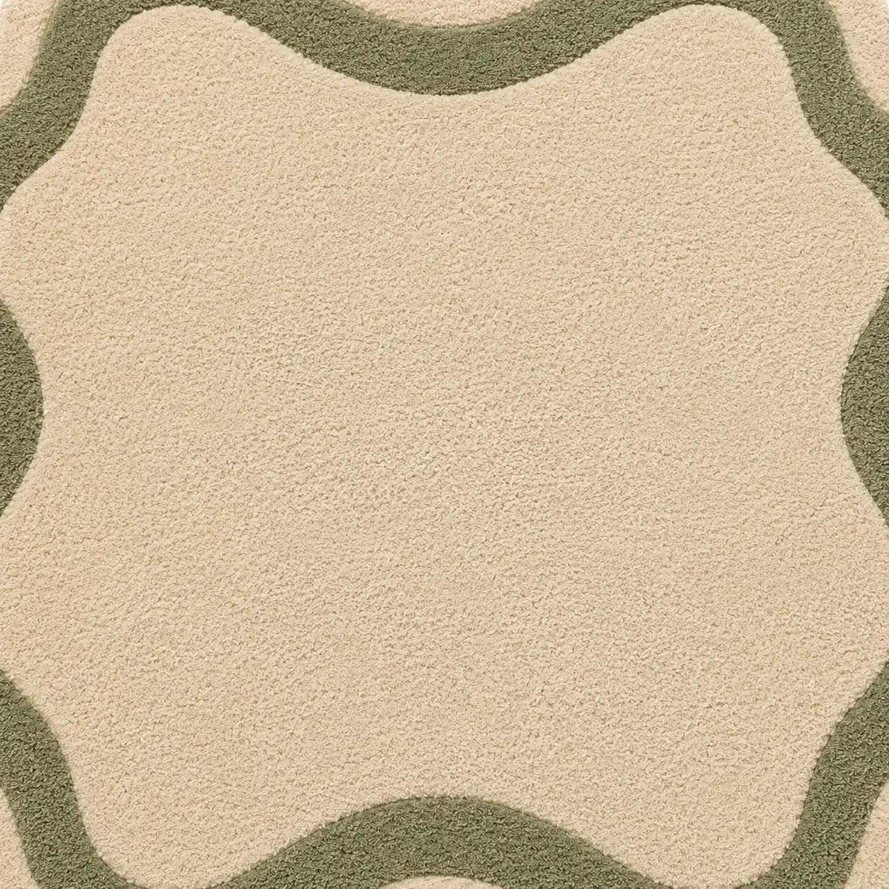 Close-up of a beige and green patterned rug