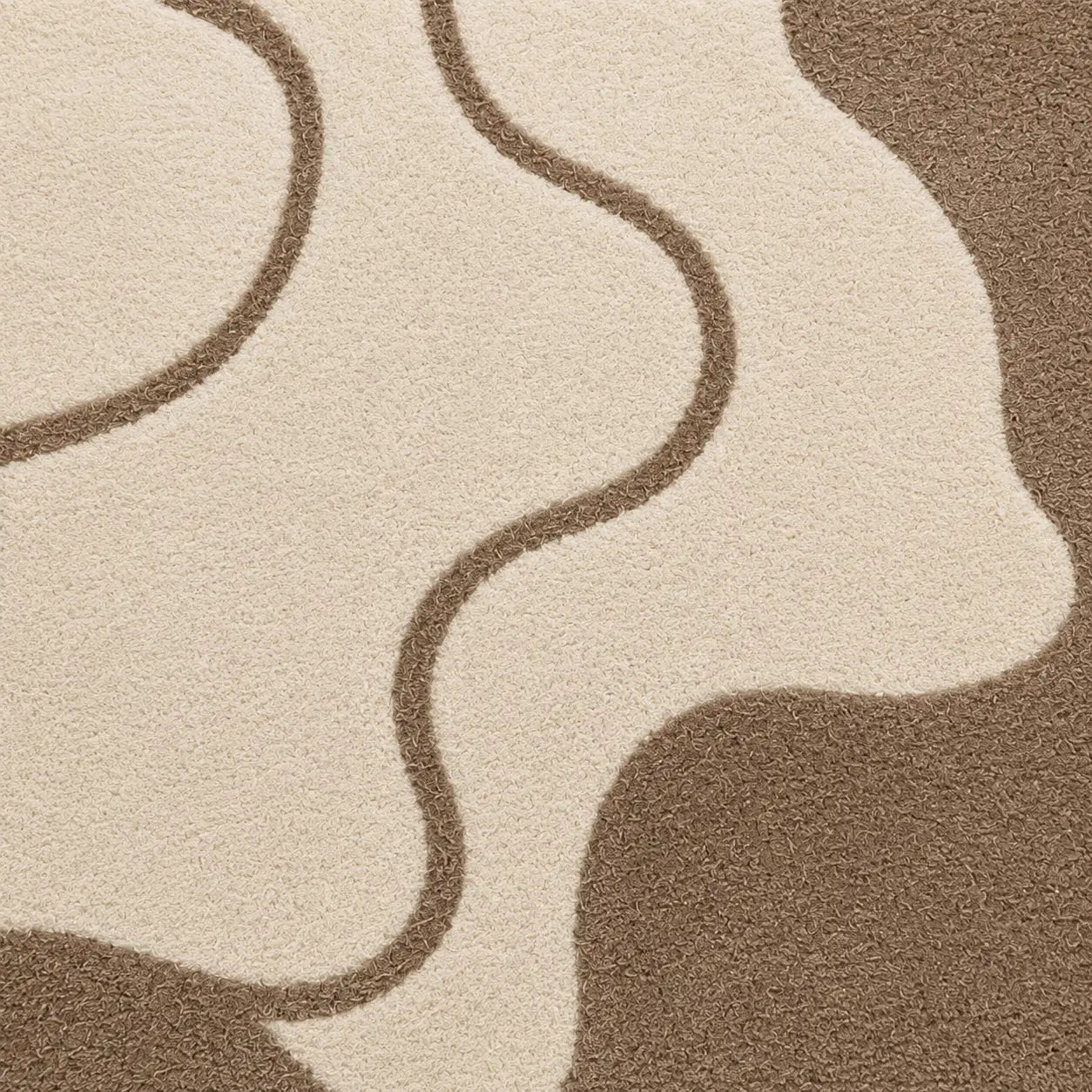 Close-up of a textured brown and beige carpet with wavy patterns