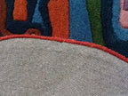 Close-up of a textured fabric with colorful patterned border