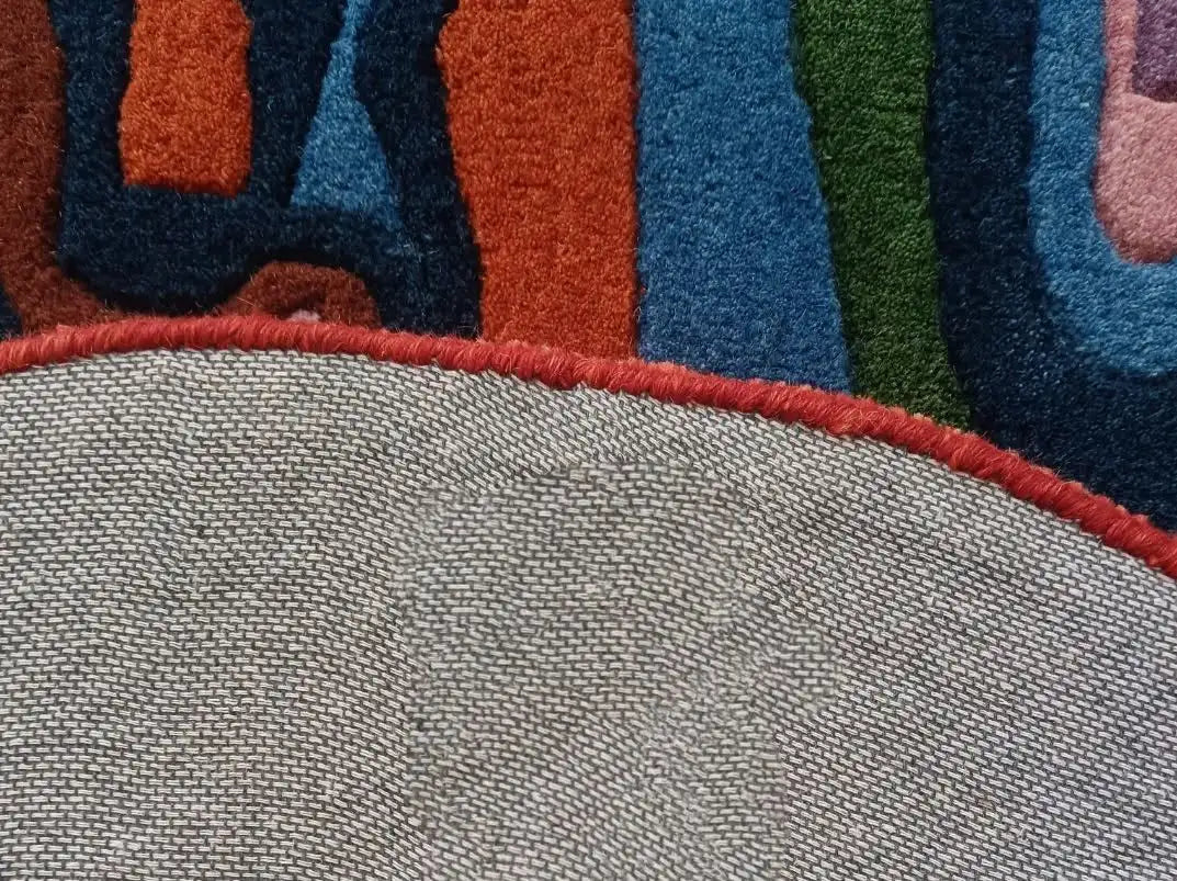 Close-up of a textured fabric with colorful patterned border