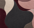 Close-up of a textured rug with wavy patterns in brown, beige, and black.