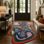 Colorful abstract rug in a living room with a black door and wooden floor.