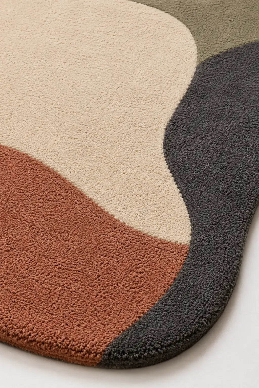 Multicolored textured rug with beige, brown, and black sections on a white background
