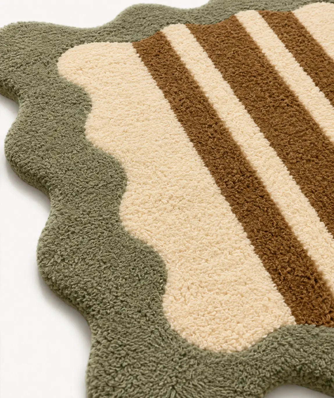 Close-up of a textured rug with green, beige, and brown stripes on a white background