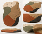 Multicolored abstract rug with brown, green, and black patterns on a white background