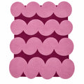 Pink circular patterned rug on a white background