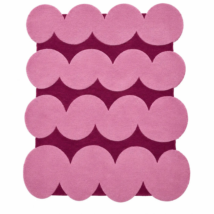 Pink circular patterned rug on a white background