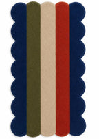 Rectangular rug with scalloped edge featuring four horizontal stripes in navy, red, beige, and green on a white background.