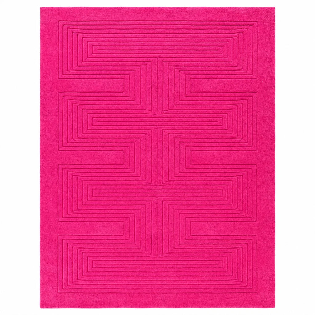 A bright pink rectangular rug with a raised geometric maze-like pattern, shown flat against a white background.