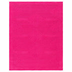 A bright pink rectangular rug with a raised geometric maze-like pattern, shown flat against a white background.